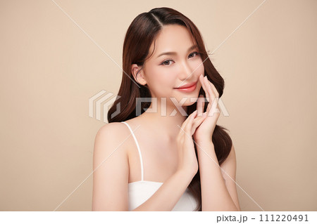 Beautiful young woman with clean fresh skin on beige background, Face care, Facial treatment, Cosmetology, beauty and spa, women portrait. 111220491