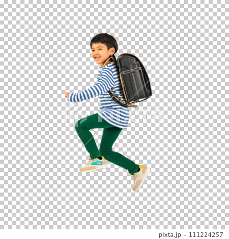 An elementary school boy jumping with a smile while carrying a school bag on his back. Full-body photo PNG with a transparent background precisely cut out by hand. 111224257