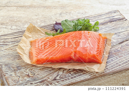 Raw salmon fillet over board 111224391