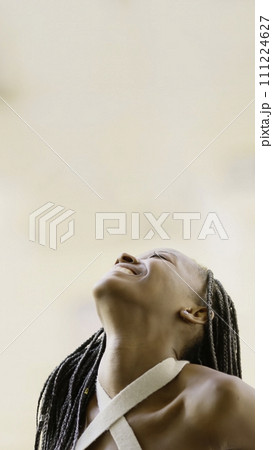 Young black woman looking up smiling 111224627