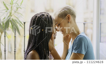 Lesbian couple about to kiss passionately at home Lesbian couple about to kiss passionately at home 111224628