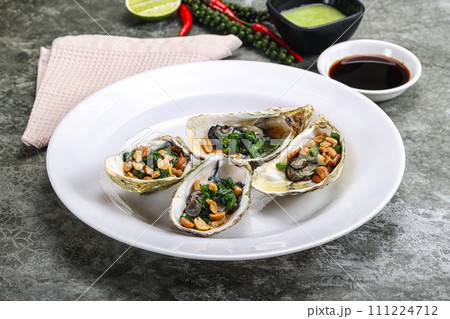 Open half oysters with green onion Open half oysters with green onion 111224712