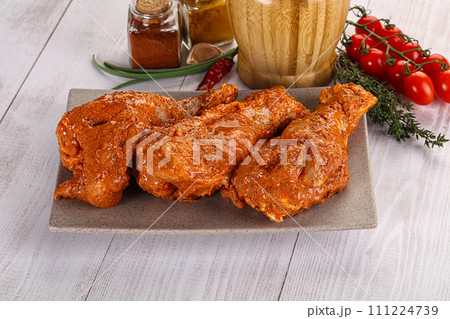 Raw turkey shoulder wing in Indian tandoori marinade 111224739