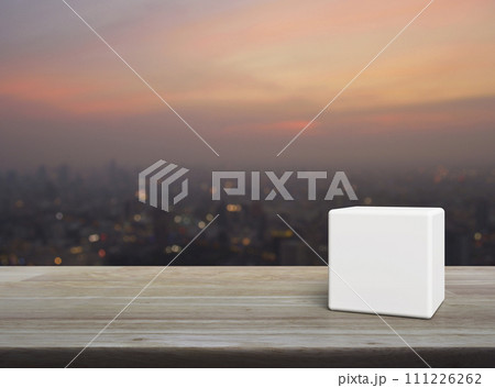 White block cube on wooden table White block cube on wooden table 111226262