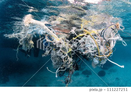 Abandoned fishing net and plastic garbage in the sea Abandoned fishing net and plastic garbage in the sea 111227251