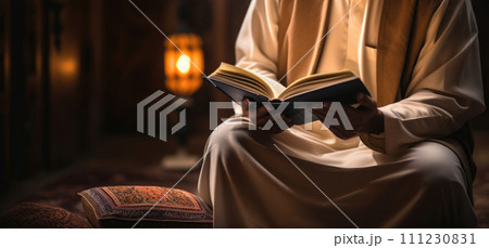 Man devoutly reads Quran, spiritual reflection and reverence shown. Man devoutly reads Quran, spiritual reflection and reverence shown. 111230831