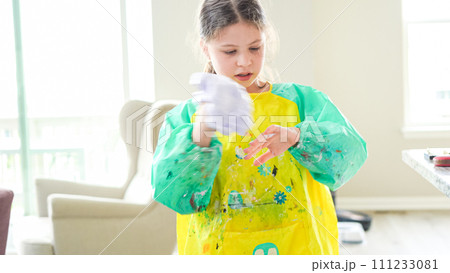 In a modern kitchen, a homeschooled girl is engrossed in creating homemade slime, a fun and educational hands-on project that enhances her creativity and problem-solving skills. In a modern kitchen, a homeschooled girl is engrossed in creating homemade slime, a fun and educational hands-on project that enhances her creativity and problem-solving skills. 111233081