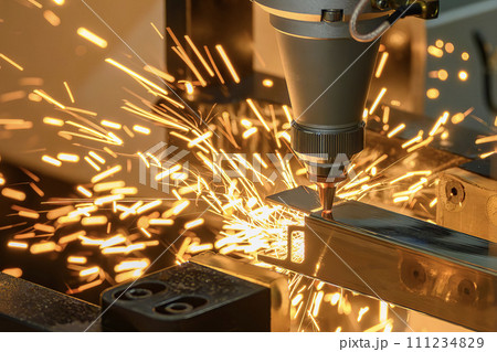 Close up scene the fiber laser cutting machine cut the square shape stainless steel tube with sparkling light. Close up scene the fiber laser cutting machine cut the square shape stainless steel tube with sparkling light. 111234829