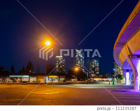 Night cityscape with skytrain rail and bright street light over the plaza 111235287