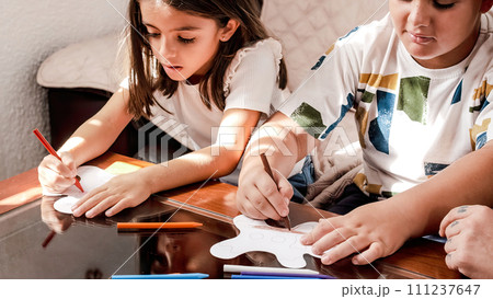 Children doing crafts at home with their mother Children doing crafts at home with their mother 111237647