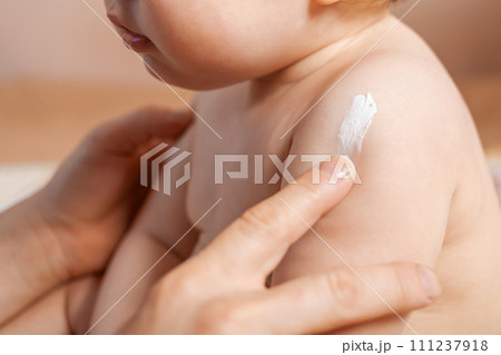 Father applying body cream on his baby Father applying body cream on his baby 111237918