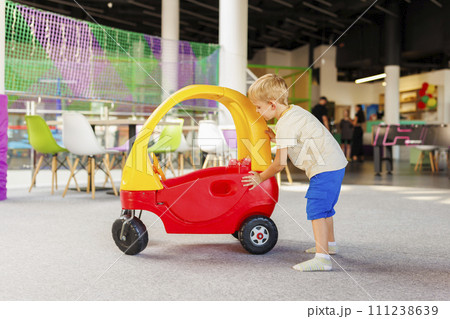 Toddler with Toy Car at Play Area Toddler with Toy Car at Play Area 111238639