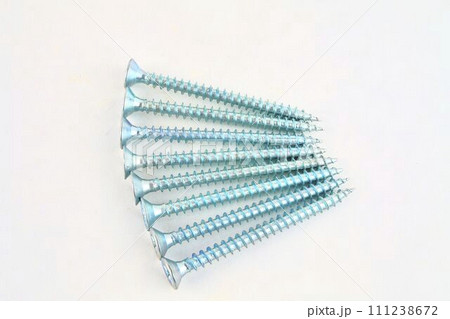 Screws for construction on a white background, metal screw, iron screw, chrome screw, screws as a background, wood screw. Close-up Screws for construction on a white background, metal screw, iron screw, chrome screw, screws as a background, wood screw. Close-up 111238672