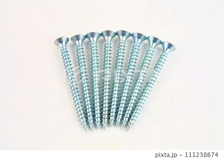 Screws for construction on a white background, metal screw, iron screw, chrome screw, screws as a background, wood screw. Close-up Screws for construction on a white background, metal screw, iron screw, chrome screw, screws as a background, wood screw. Close-up 111238674