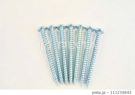 Set of screws for construction on a white background, metal screw, iron screw, chrome screw, screws as a background, wood screw. Close-up Set of screws for construction on a white background, metal screw, iron screw, chrome screw, screws as a background, wood screw. Close-up 111238692