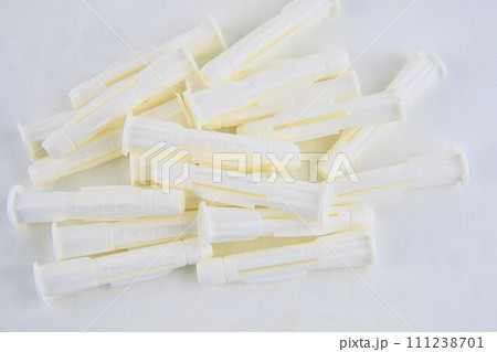 Plastic wall plugs for fastener screw. Material made of plastic for construction. Home equipment for repairing Plastic wall plugs for fastener screw. Material made of plastic for construction. Home equipment for repairing 111238701
