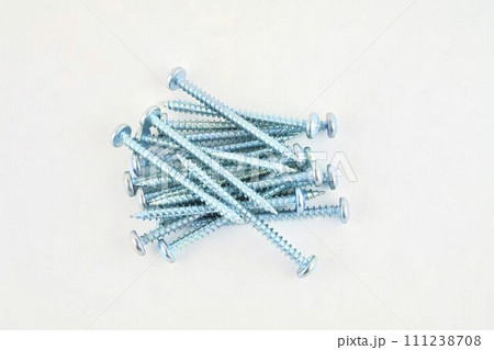 Set of screws for construction on a white background, metal screw, iron screw, chrome screw, screws as a background, wood screw. Close-up 111238708