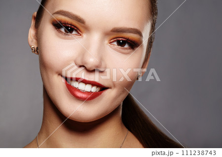 Elegance close-up of female eye with classic dark brown smoky make-up. Macro shot of woman's face part. Beauty, cosmetics and makeup Elegance close-up of female eye with classic dark brown smoky make-up. Macro shot of woman's face part. Beauty, cosmetics and makeup 111238743
