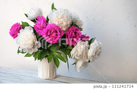 Bouquet of peonies and roses on a table 111241714