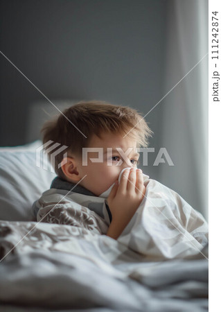 Caucasian boy blows his nose in bed ,The nose doesn't stop running. 111242874