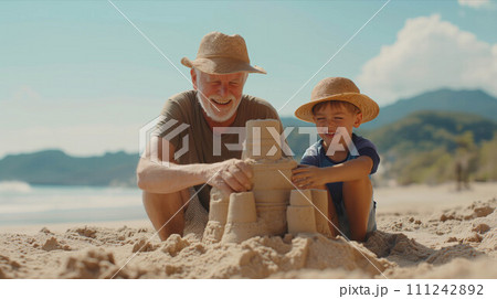 Caucasian grandfather and grandson build sand on the beach. Caucasian grandfather and grandson build sand on the beach. 111242892