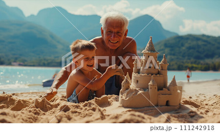 Caucasian grandfather and grandson build sand on the beach. 111242918