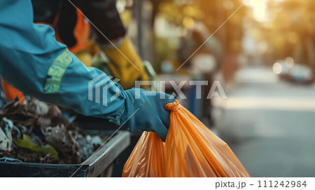Close-up of the hand of a garbage collector in the city. 111242984