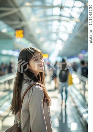 Asian female tourist walking at airport passenger building. 111243259