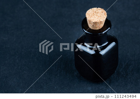 Retro vintage apothecary black glass bottle on black Retro vintage apothecary black glass bottle on black 111243494