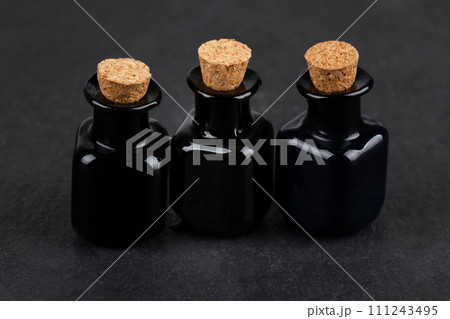 Retro vintage apothecary black glass bottles on black Retro vintage apothecary black glass bottles on black 111243495