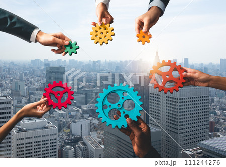 Business team connect pieces of gears like a teamwork and partners 111244276