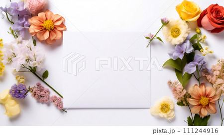 Flowers and envelope on white background. Postcard mockup. Floral frame of spring flowers. Flowers and envelope on white background. Postcard mockup. Floral frame of spring flowers. 111244916
