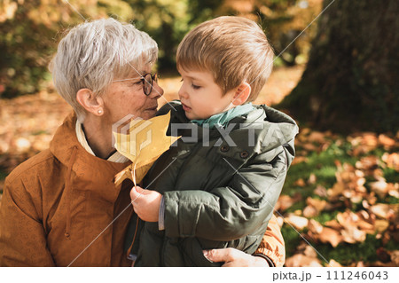 French gray-haired grandmother with her grandson French gray-haired grandmother with her grandson 111246043