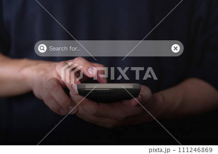 Male hand using a smartphone for internet search bar. SEO technology networking engine optimization internet with search bar. Searching browsing internet data information concept. 111246869