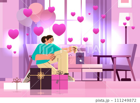 girl in love opening gift boxes in living room with pink air balloons in heart shape happy valentines day celebration concept 111249872