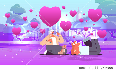 senior couple in love blowing bubbles and spending time with little dog in urban park valentines day celebration concept horizontal 111249906