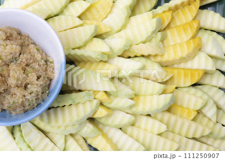 Sliced raw mango with chili and salt Sliced raw mango with chili and salt 111250907
