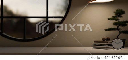 A space for displaying your product on a tabletop against the wall with a round window. 111251064