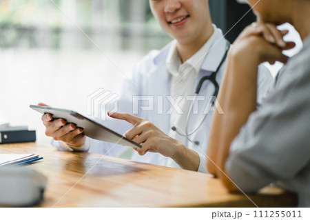 Young male doctor discussing about diagnosis to senior woman patient. Young male doctor discussing about diagnosis to senior woman patient. 111255011