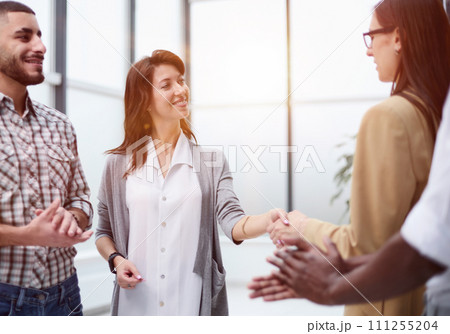 Laughing multiethnic business people talking in the office. Laughing multiethnic business people talking in the office. 111255204
