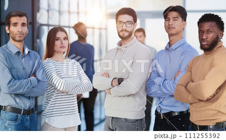 Group of successful businesspeople standing in row and looking at camera at office 111255392