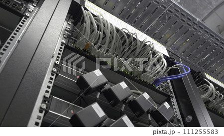 Storage servers are located in the server room of the data center. Back of the server installed in the server room. Many cables are connected to a powerful computers 111255583