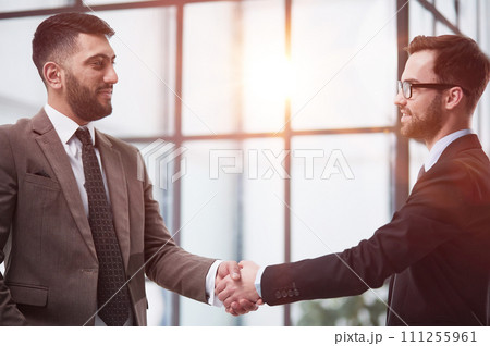 director of the company, glad to meet his new colleague. Handshake and new employee concept. 111255961