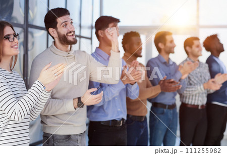 Close up side profile, different participants business people stand and express appreciation by clapping their hands 111255982