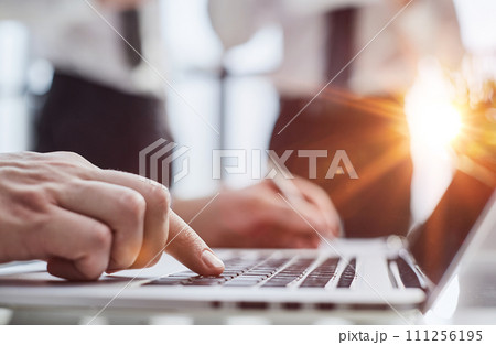 Man hands typing on laptop computer keyboard, close up. 111256195