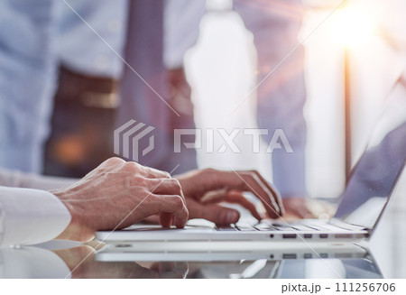 Man hands typing on laptop computer keyboard, close up. 111256706