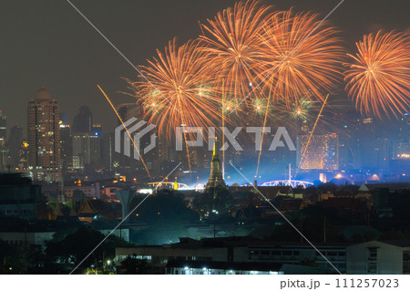 Fireworks of Temple of Dawn or Wat Arun with urban city town in Rattanakosin Island in architecture, Urban old town city, Bangkok skyline. downtown area at night, Thailand. 111257023