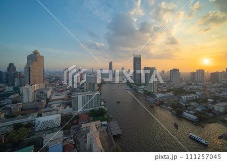 Aerial view of Bangkok Downtown Skyline with Chao Phraya River, Thailand. Financial district and business centers in smart urban city in Asia. Skyscraper and high-rise buildings. Aerial view of Bangkok Downtown Skyline with Chao Phraya River, Thailand. Financial district and business centers in smart urban city in Asia. Skyscraper and high-rise buildings. 111257045