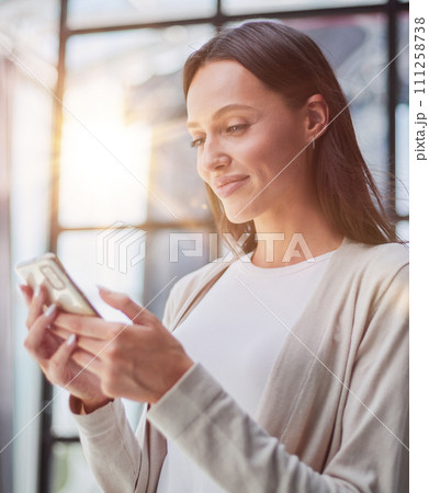 Businesswoman with phone in modern office 111258738