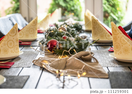 Festive dinner table setting decoration for christmas with Paper, lights 111259301